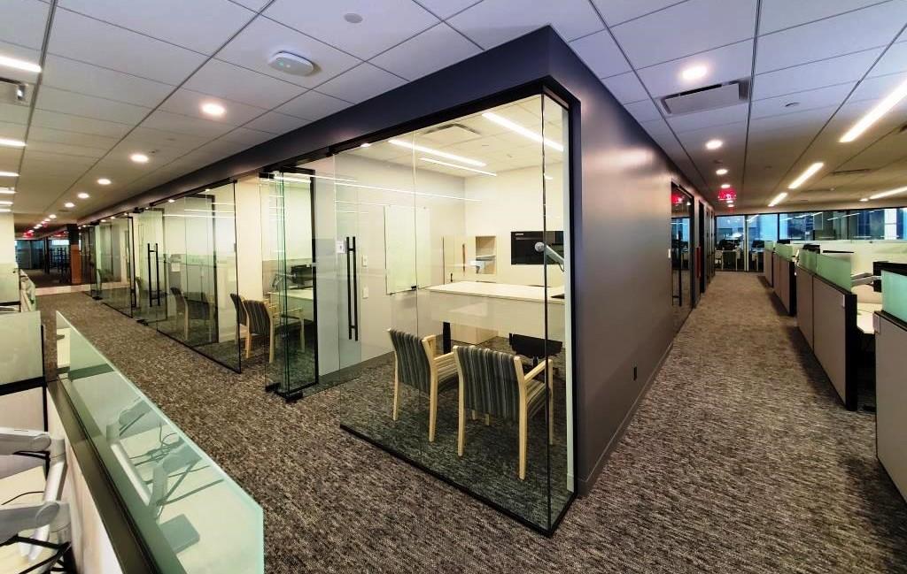 Cluster of glass walled offices and teaming spaces
