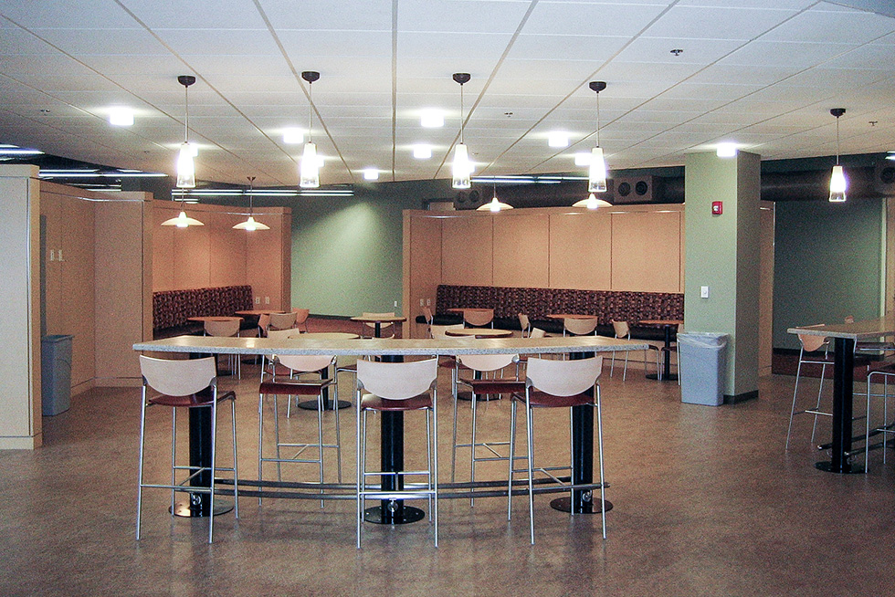 The staff lounge offers a variety of seating options. It is used for breaks, meetings and gatherings.
