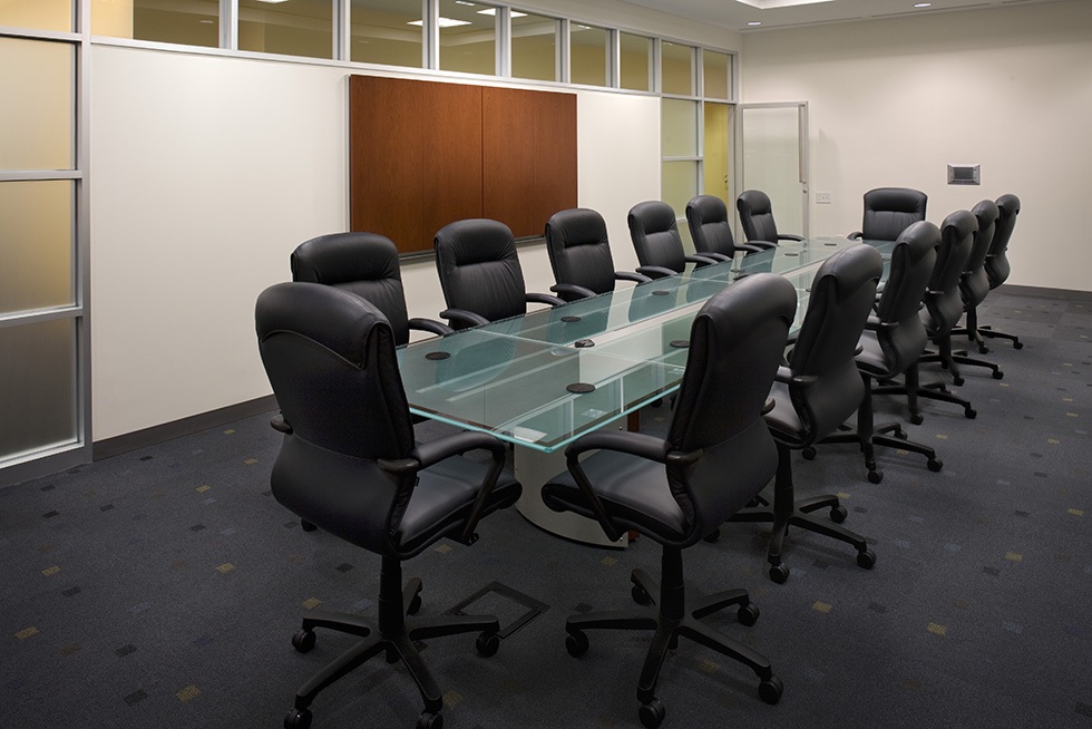Conference/meeting accommodates 12-14 people around a modern glass top table