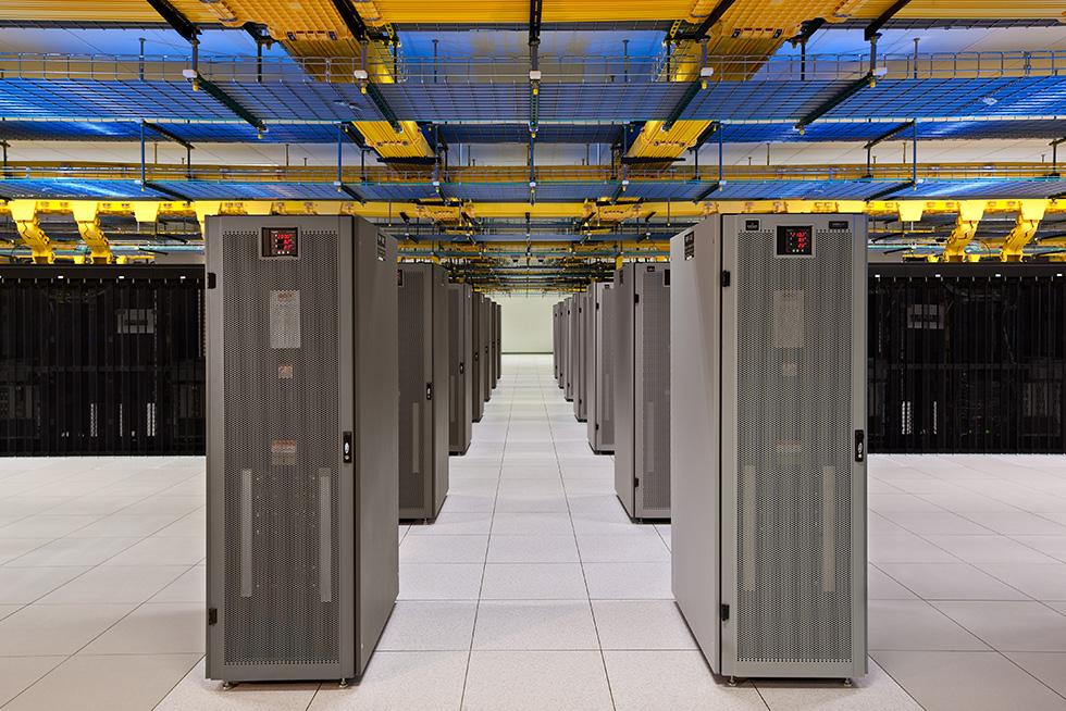 The data center is well organized. Cabinets are arranged in hot/cold aisle configuration with end-of-aisle remote power panels (RPPs). Redundant and diverse fiber and cable connectivity is distributed overhead.