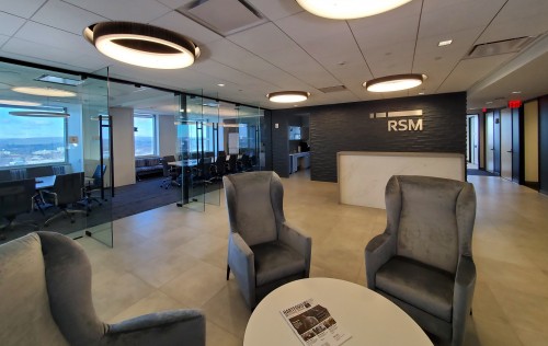 Reception area lobby features an informal seating area, reception desk and conference room