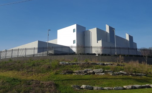 LEED Silver Facility with site security including natural berms, stone walls, and a shaker system fence in addition to CCTV and other features sets the tone for this secure facility.