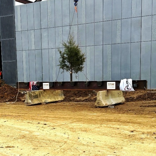 The signed topping off beam with ceremonial evergreen and American Flag ready to take flight